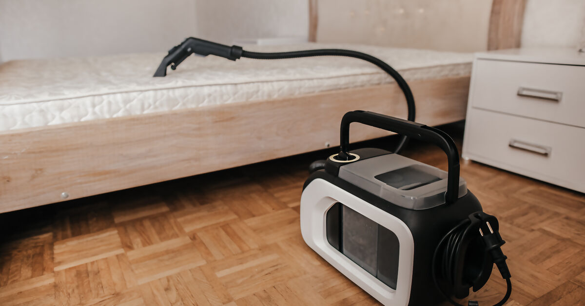 Professional cleaning machine next to bed