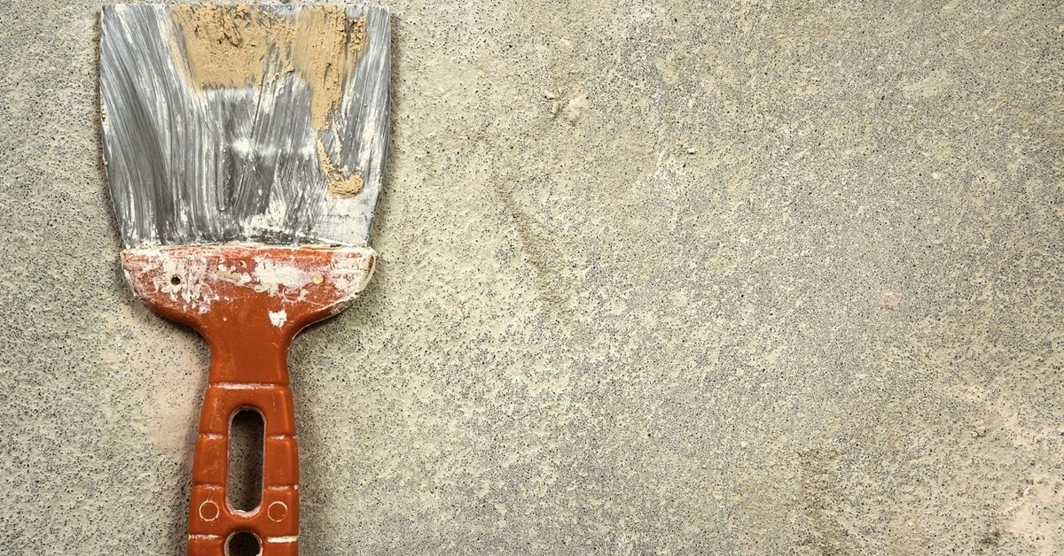 Plastic scraper near dried paint