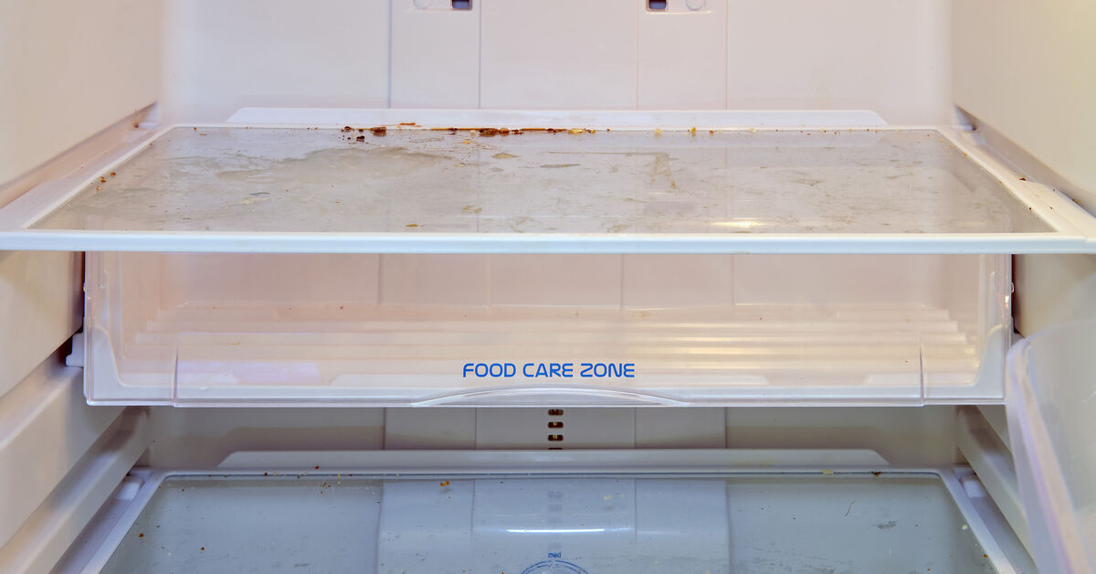 Dirty refrigerator shelf with visible spill